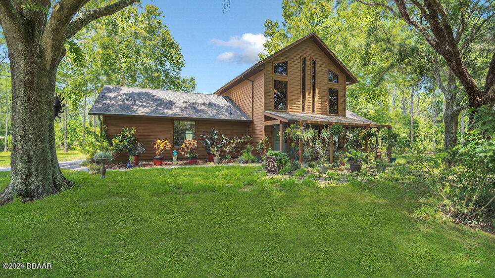 a front view of house with yard and green space