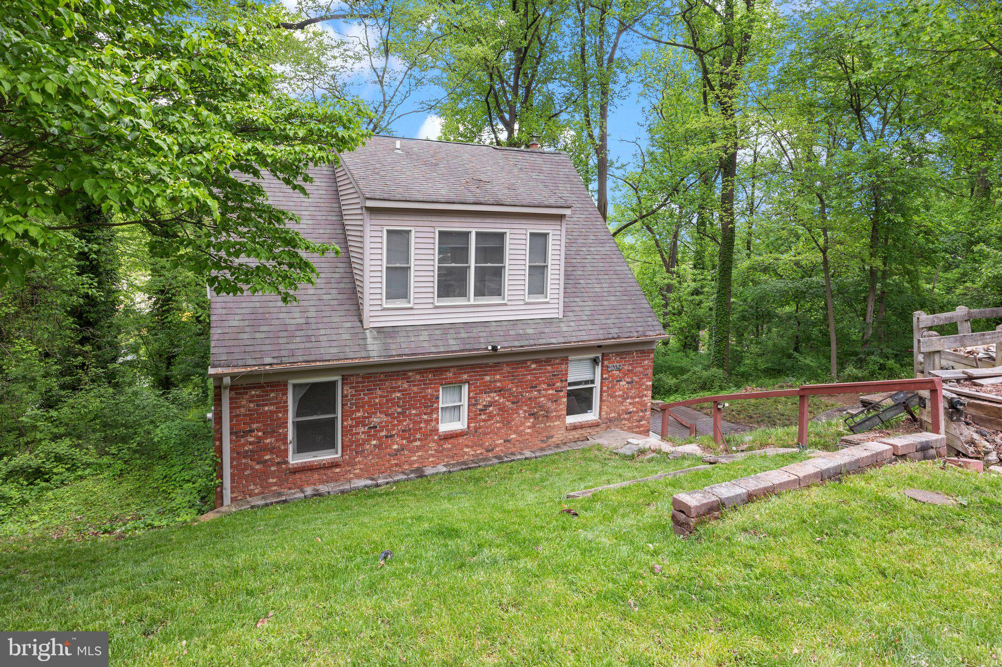 a aerial view of a house with a yard and sitting area