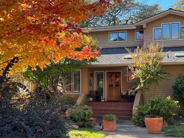 a front view of a house with plants