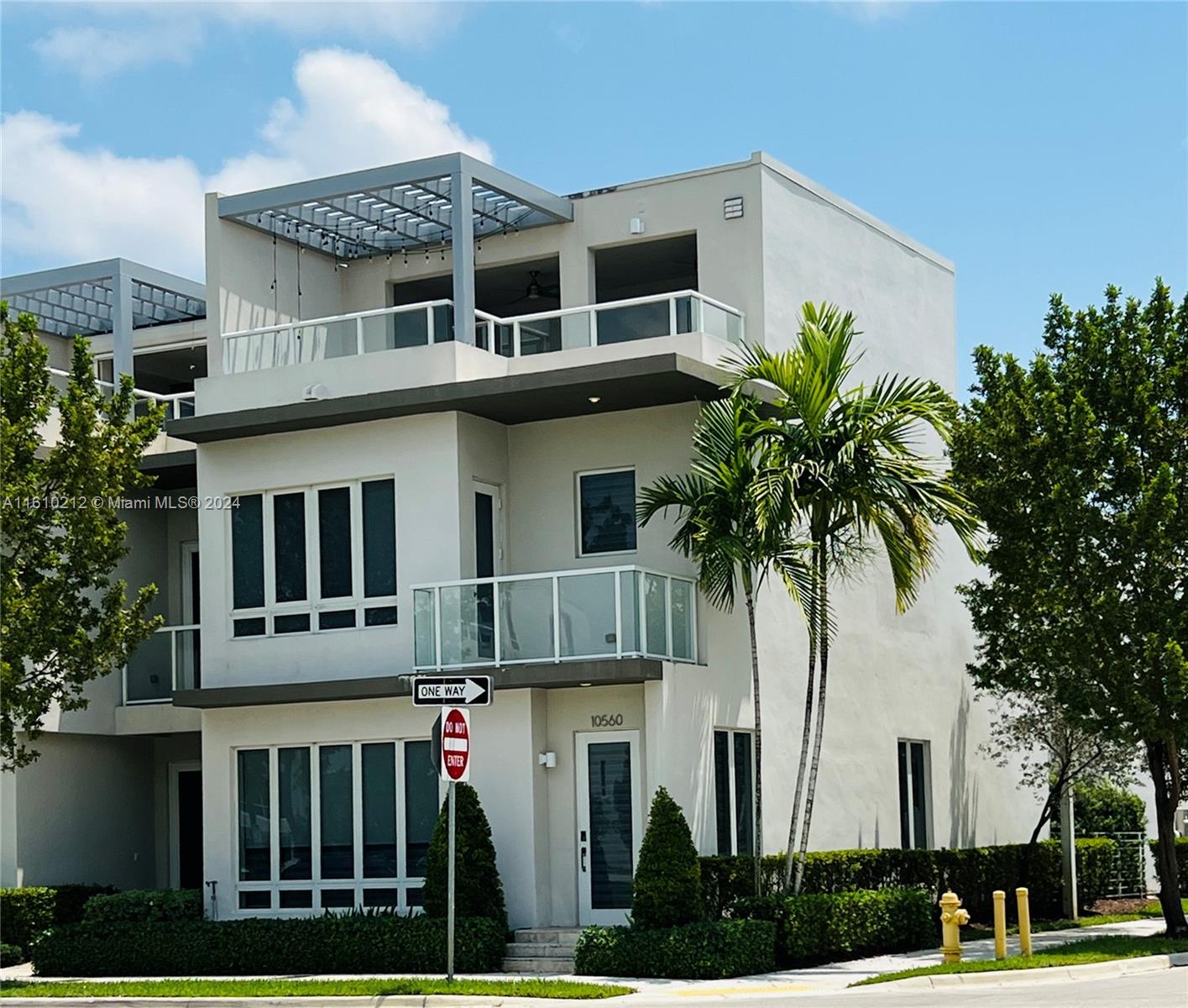 a front view of multiple houses with yard