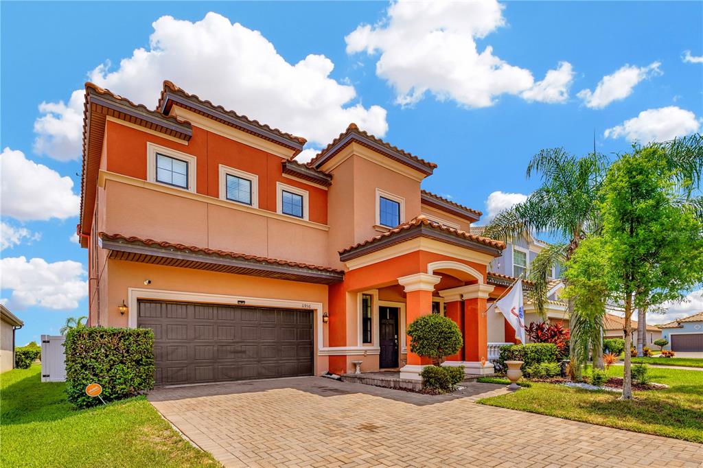 front view of a brick house with a yard