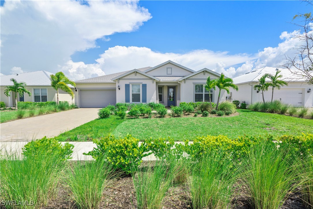 a front view of a house with a garden