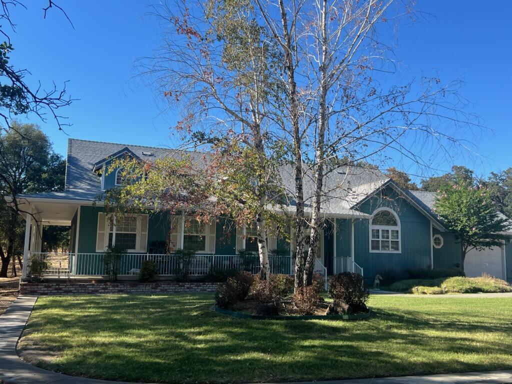 a front view of a house with a garden