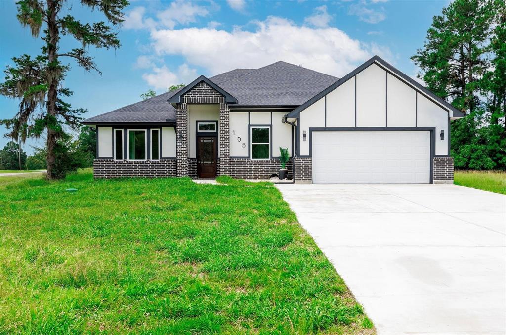 a front view of house with yard and green space