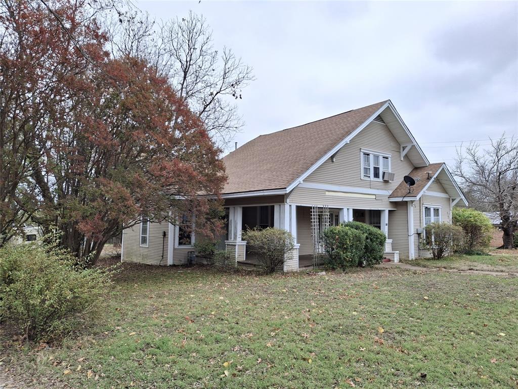 a front view of house with yard and trees around