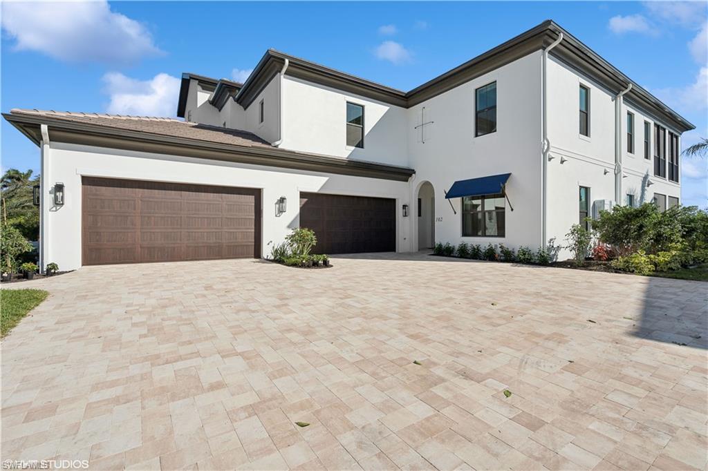 a view of a white house with a outdoor space