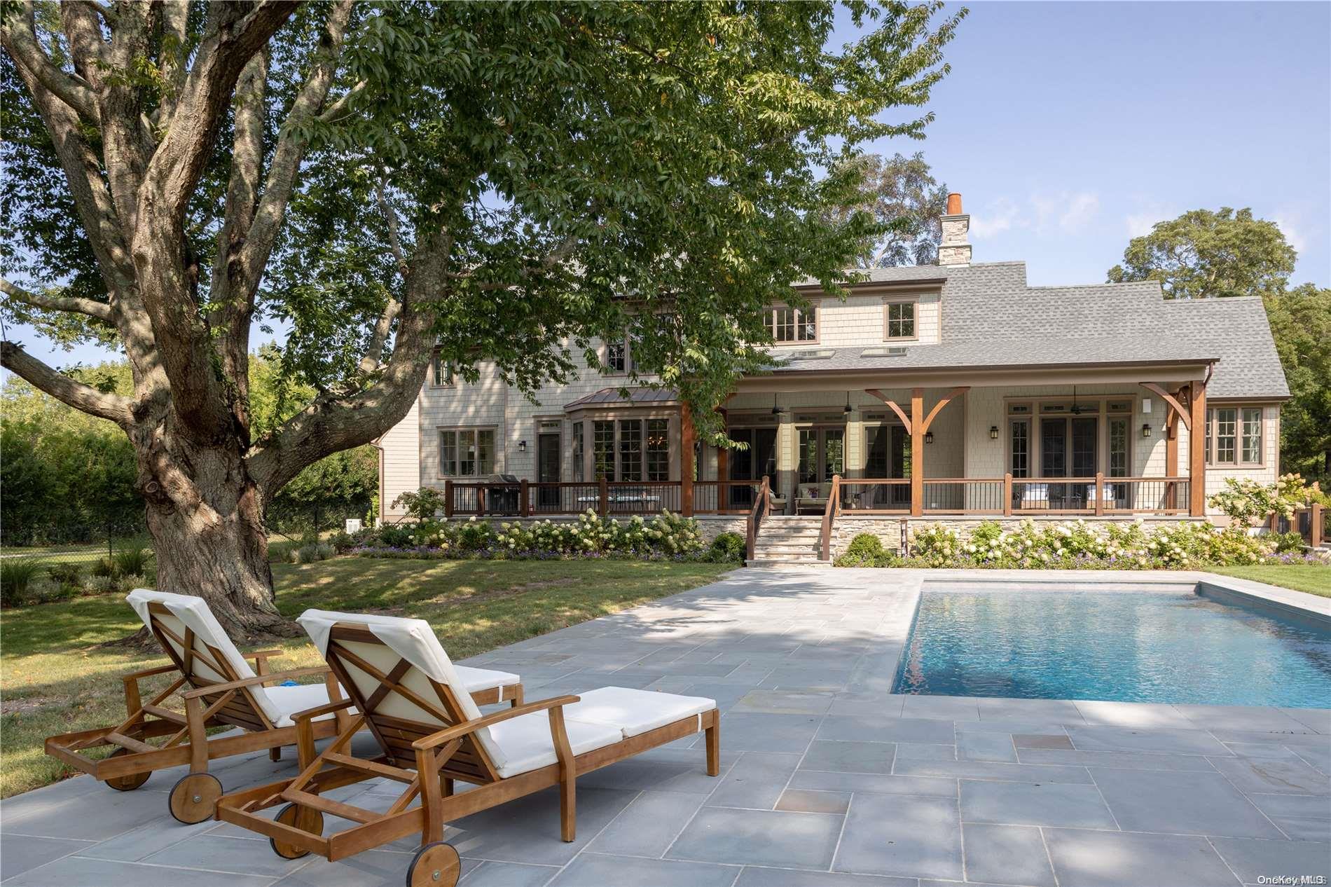 a view of a house with backyard porch and sitting area