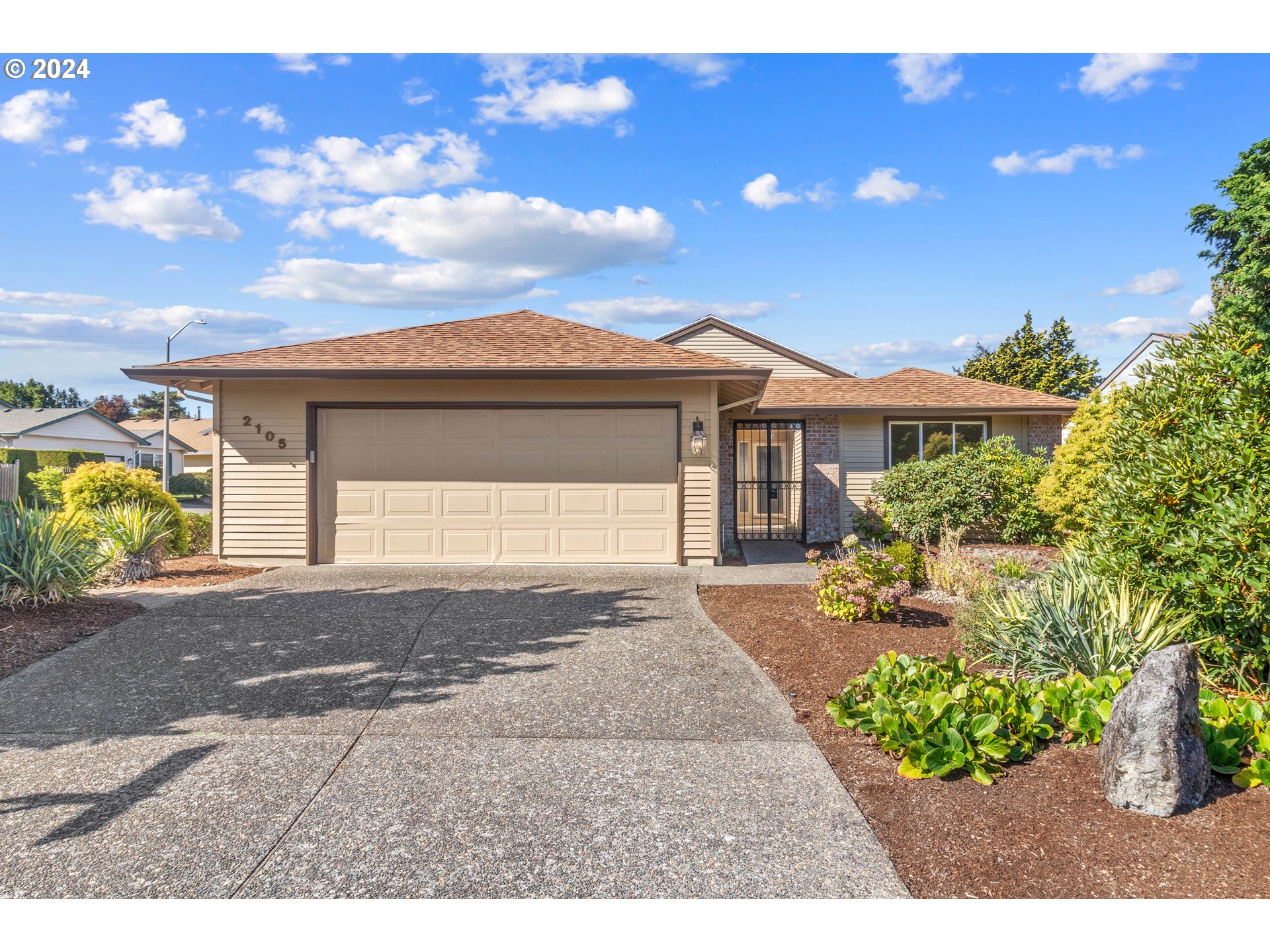 a front view of a house with a yard and a garage