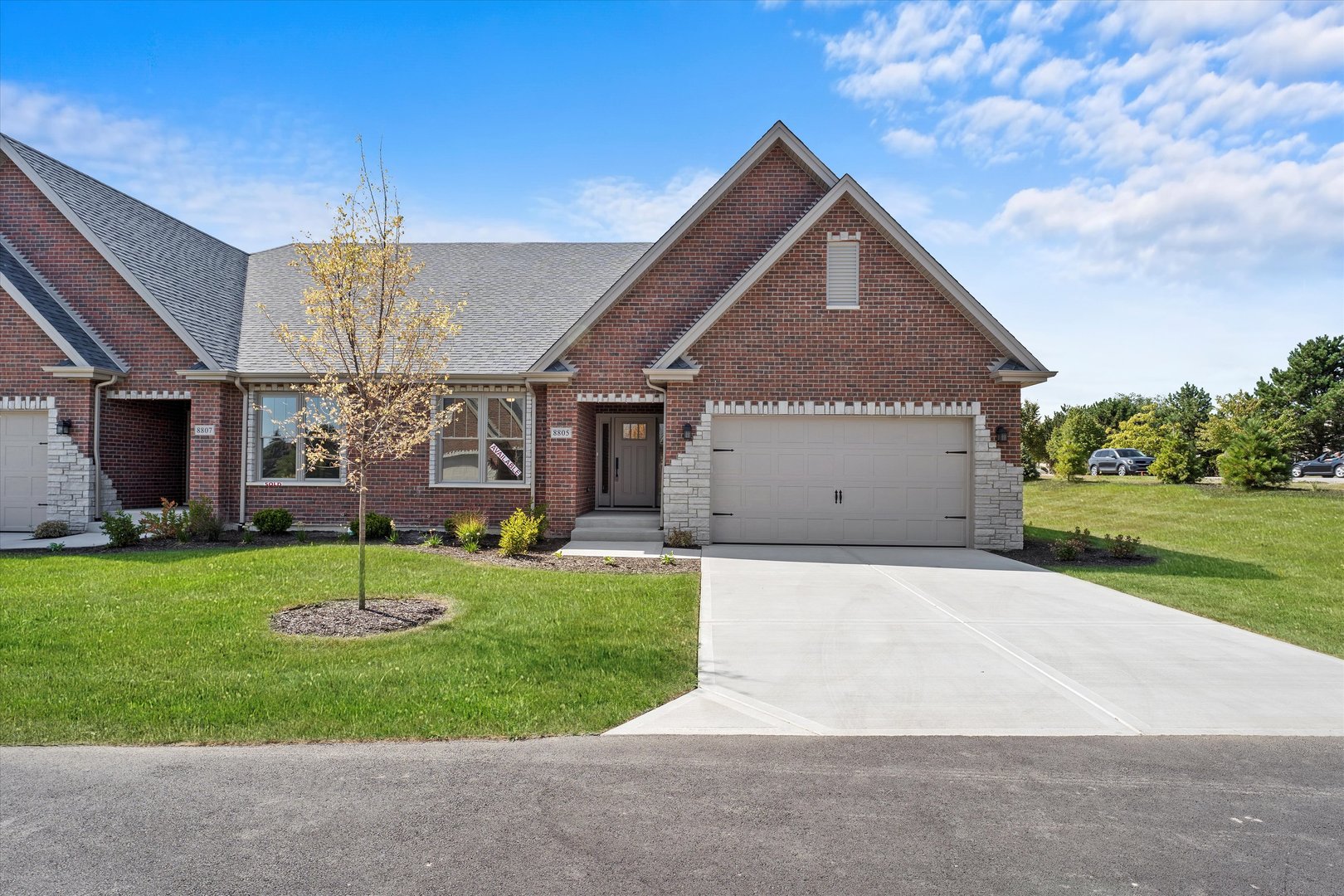 a front view of a house with a yard and garage