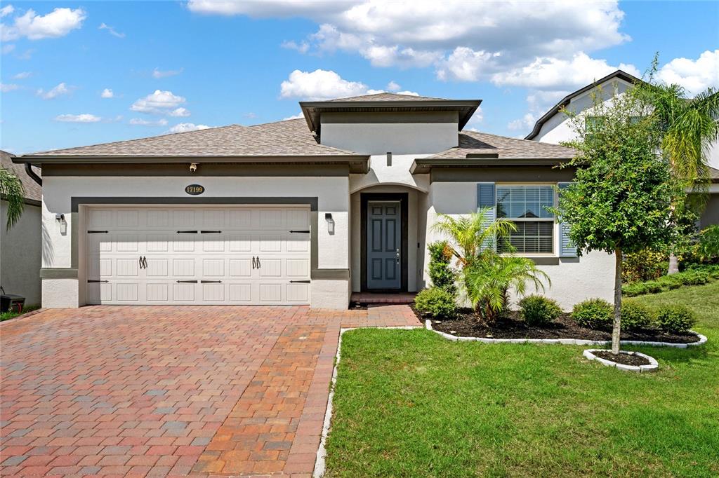 a front view of a house with a yard and garage