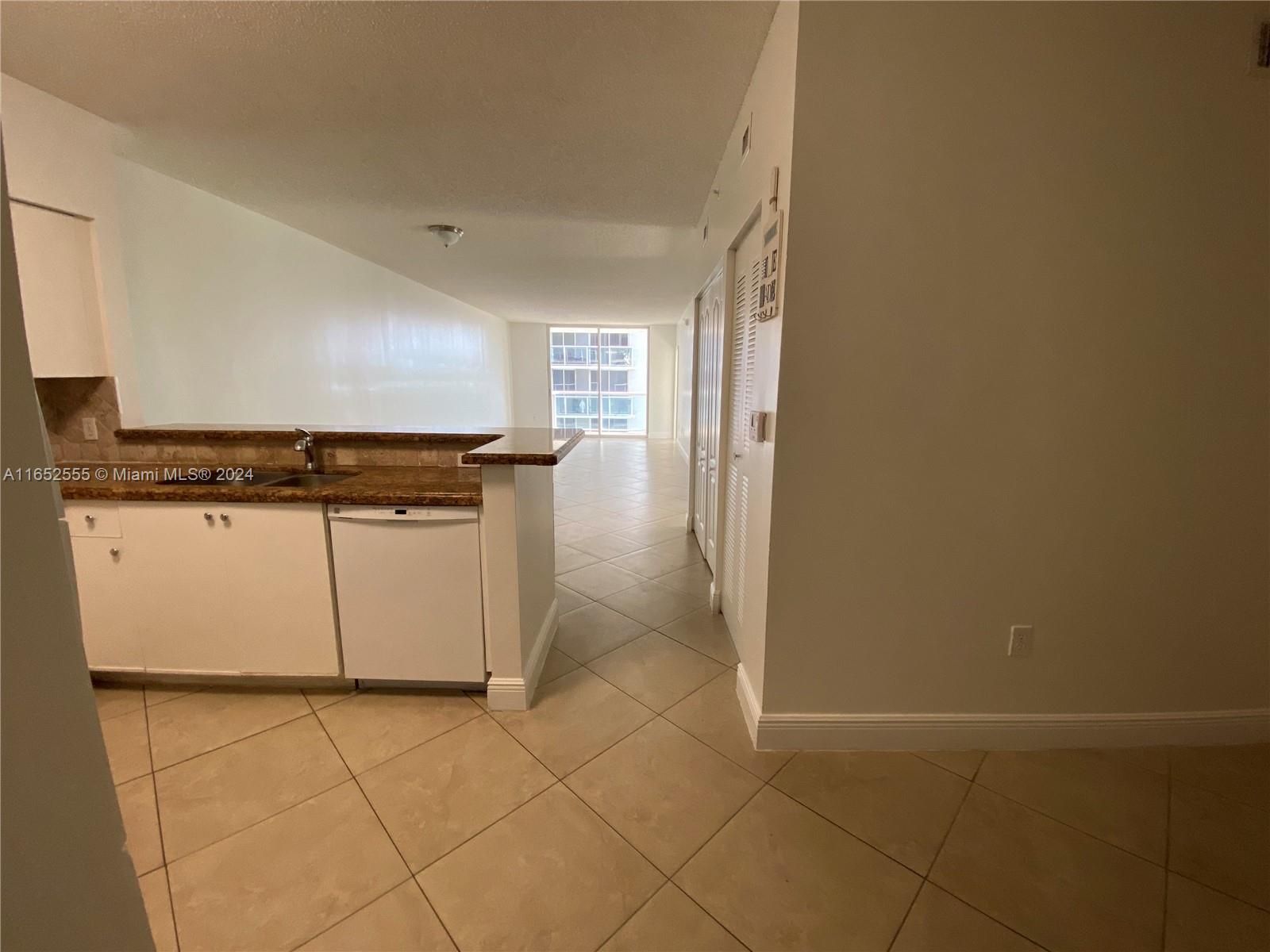 a view of a kitchen with cabinets