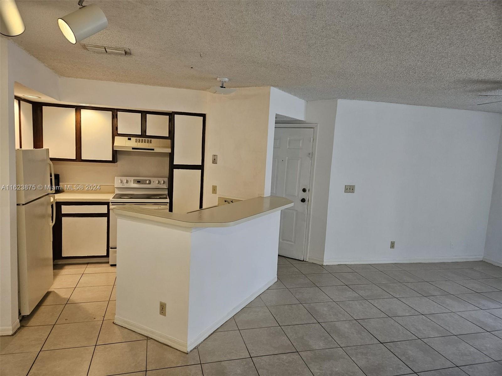 a view of kitchen with cabinets and wooden floor