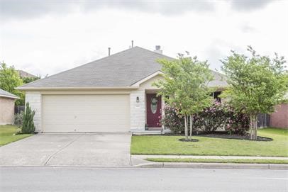 a front view of house with a garden