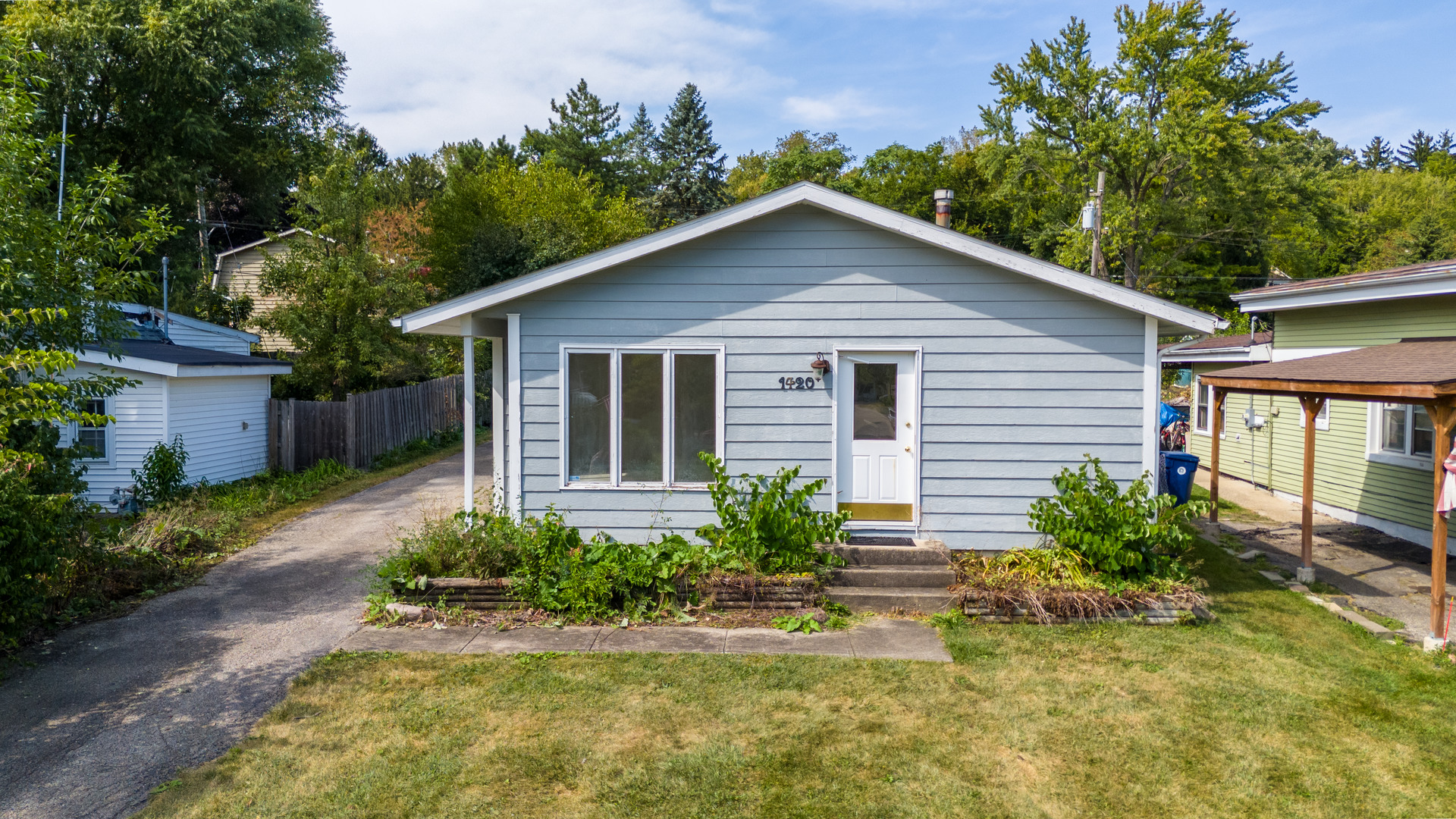 a front view of house with yard and green space