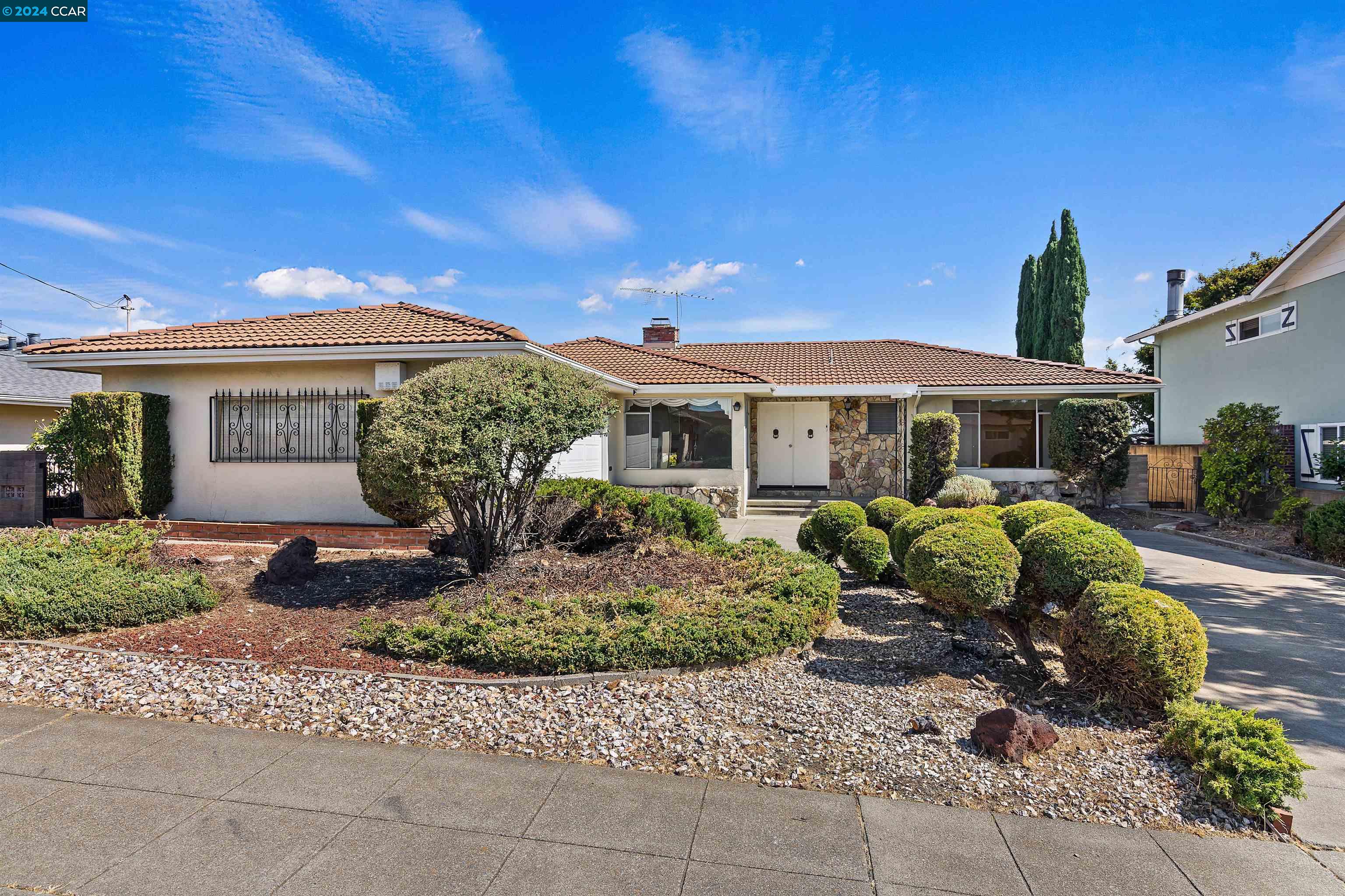 a front view of a house with garden