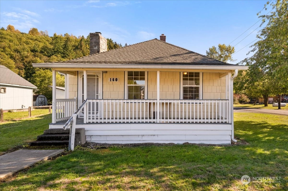 a front view of a house with a garden