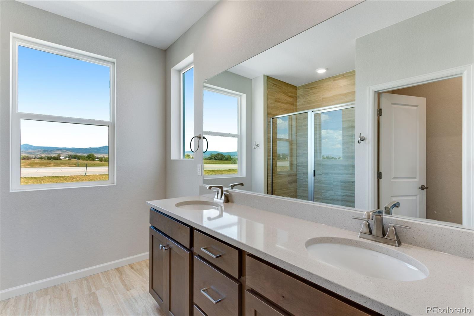 a bathroom with a granite countertop sink a mirror and a window