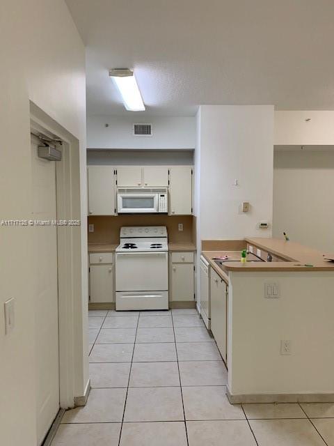 a kitchen with a stove top oven and cabinets