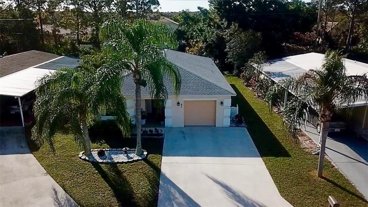 a view of house with backyard space and seating area