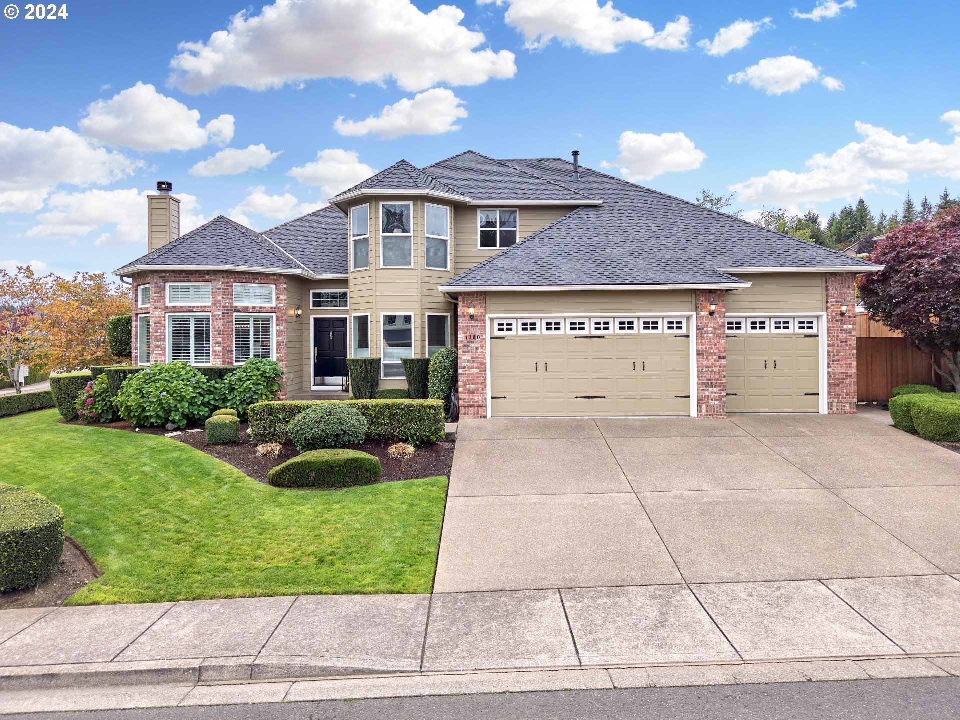 a front view of a house with garden