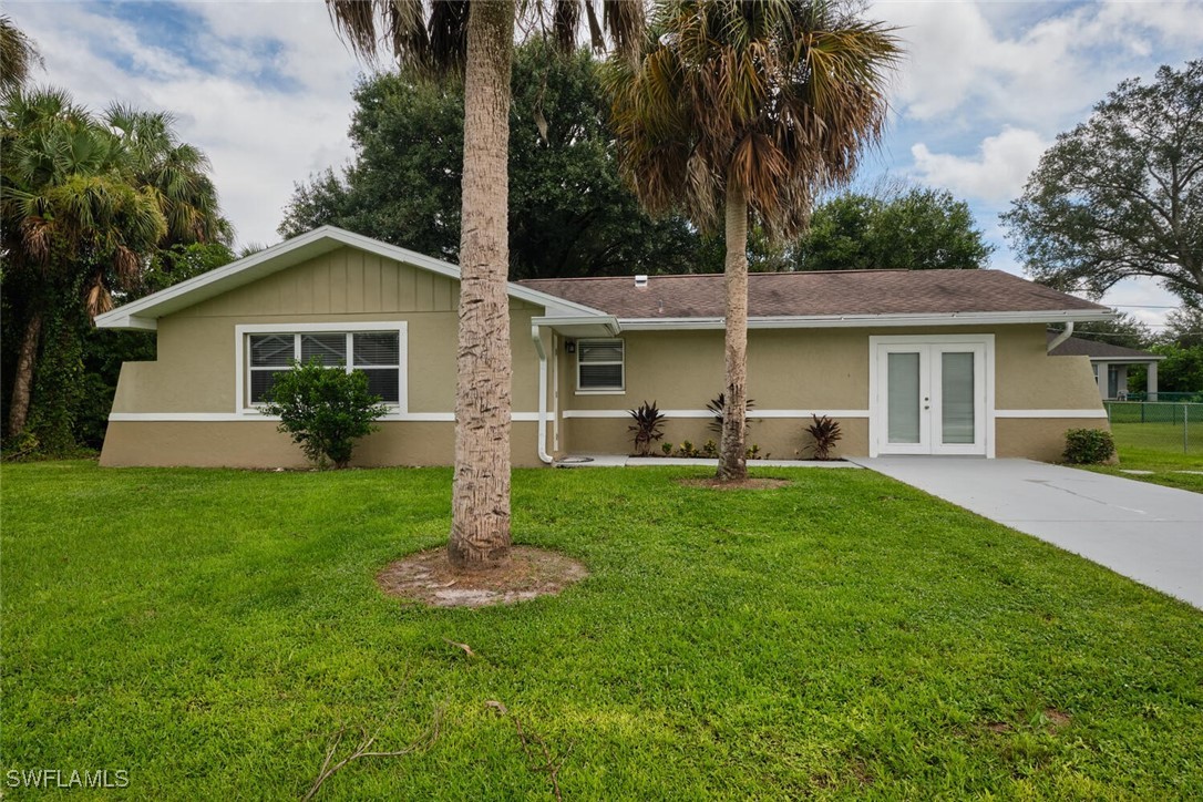 a front view of house with a garden and yard