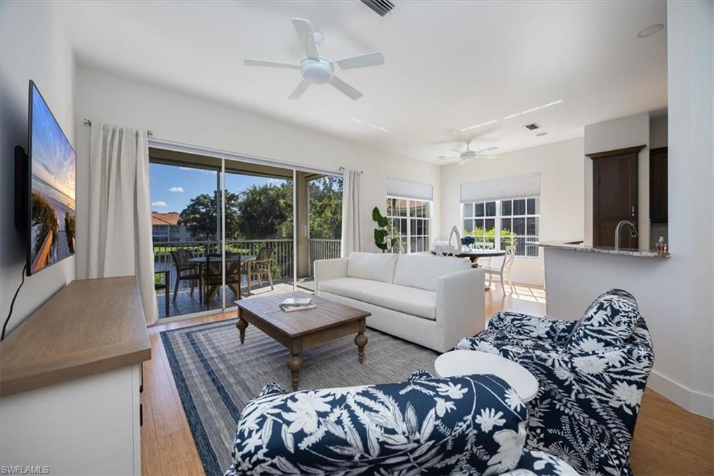 Living room with light hardwood / wood-style floors, sink, ceiling fan, and plenty of natural light