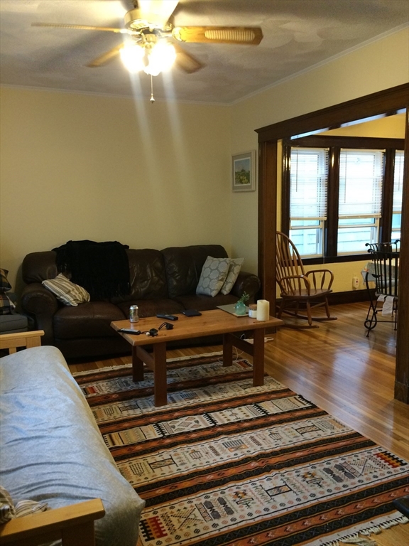 a living room with furniture and floor to ceiling window