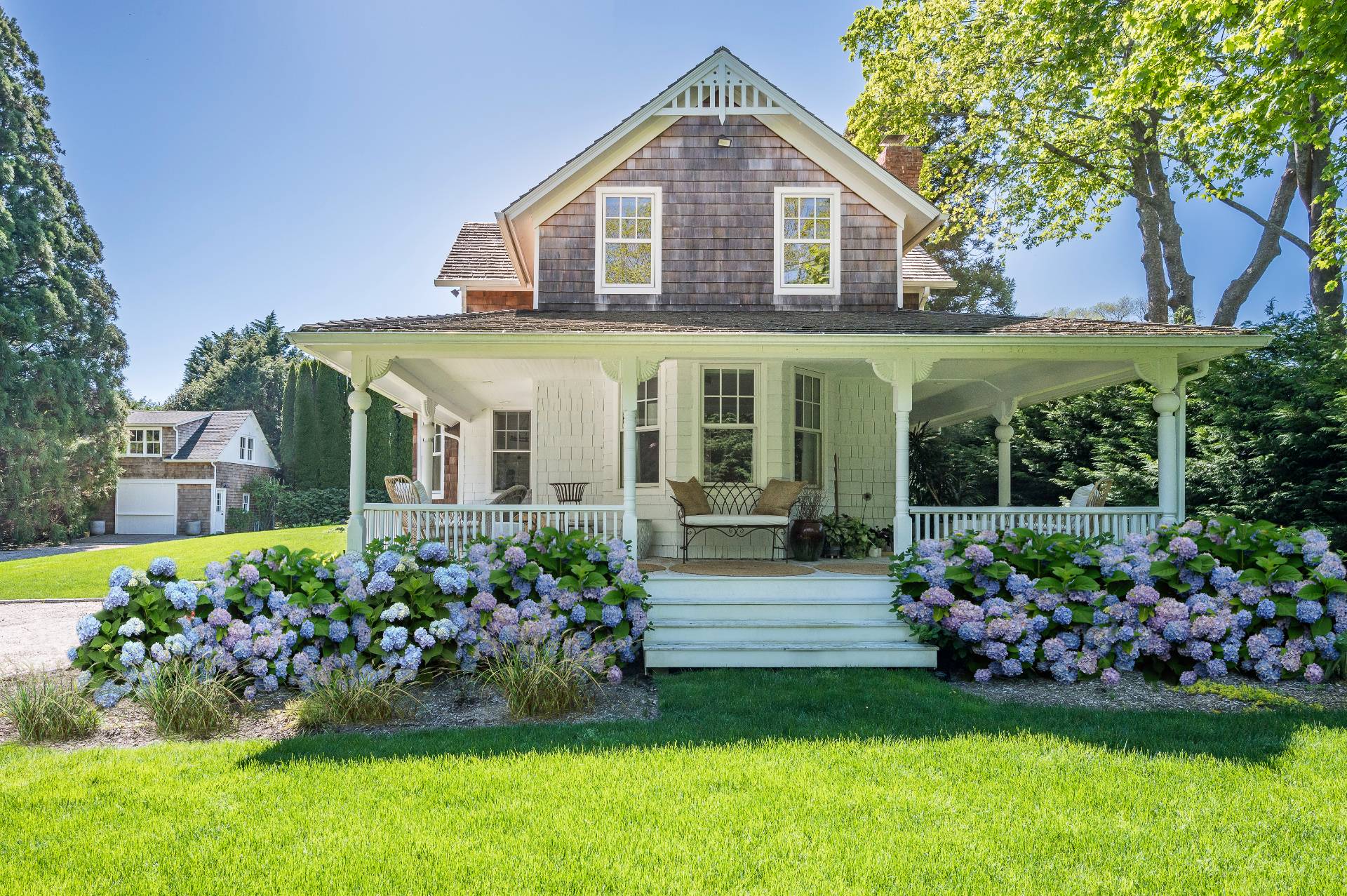 a front view of a house with a garden