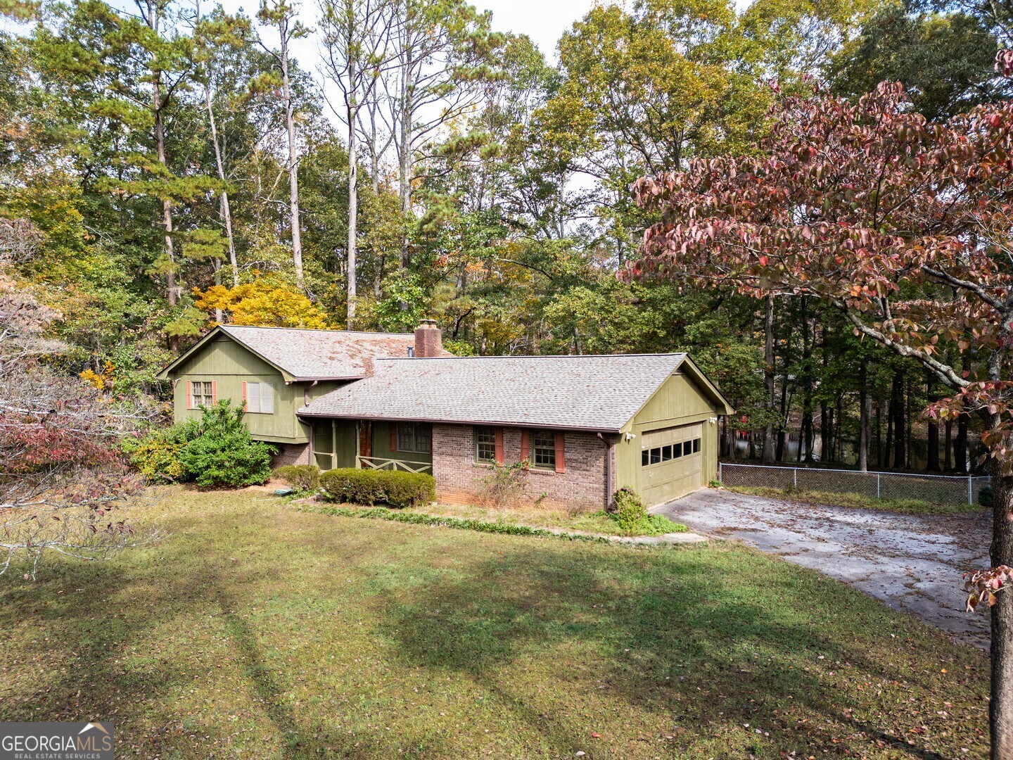 a view of a house with a yard and sitting area