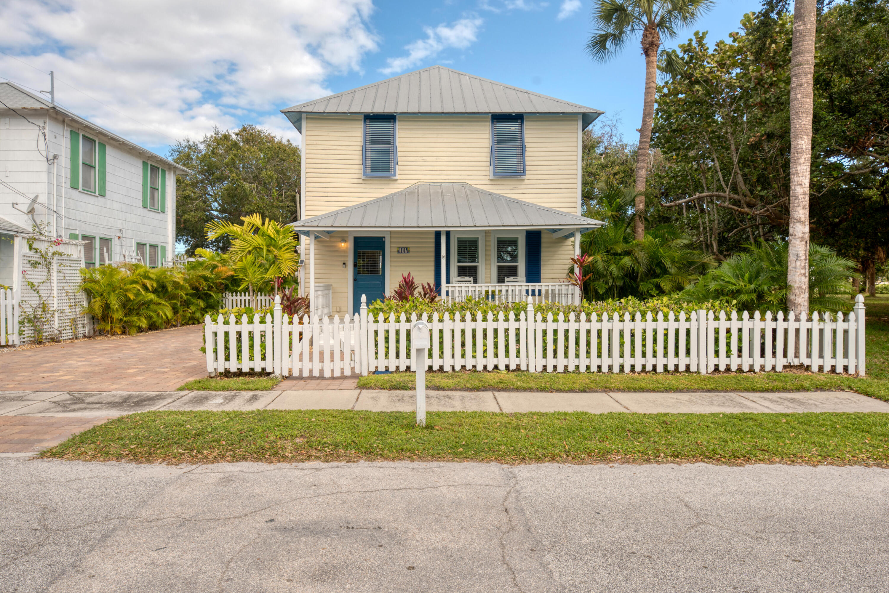 a front view of a house with a garden