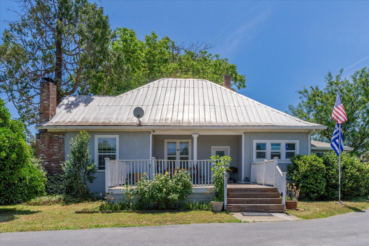 a front view of a house with a garden