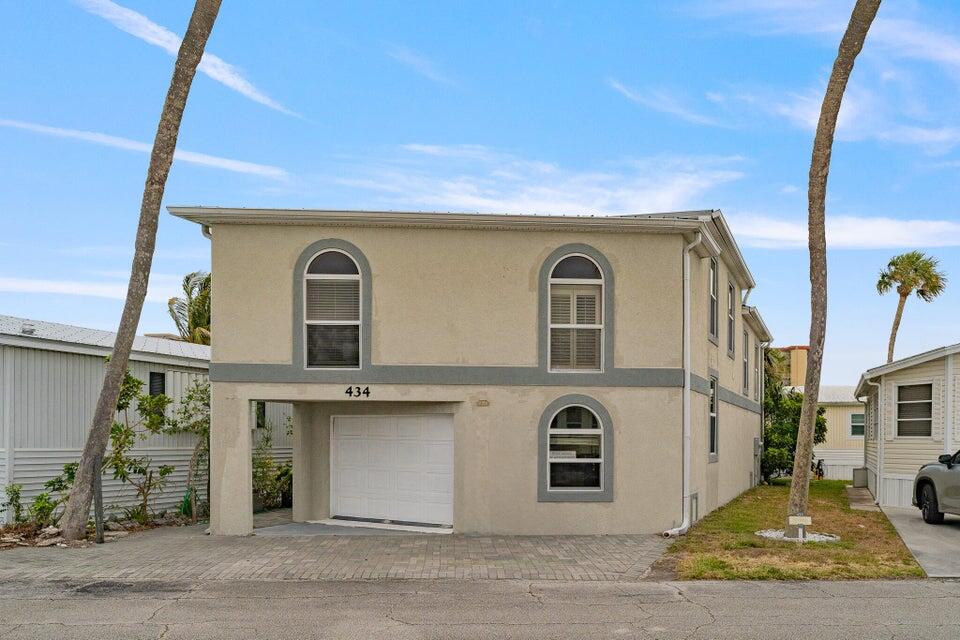 a front view of a house with parking