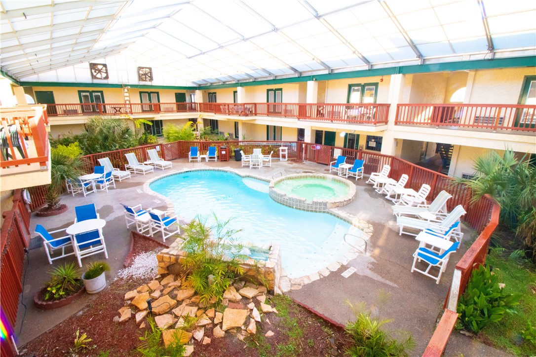 a view of a swimming pool with outdoor seating