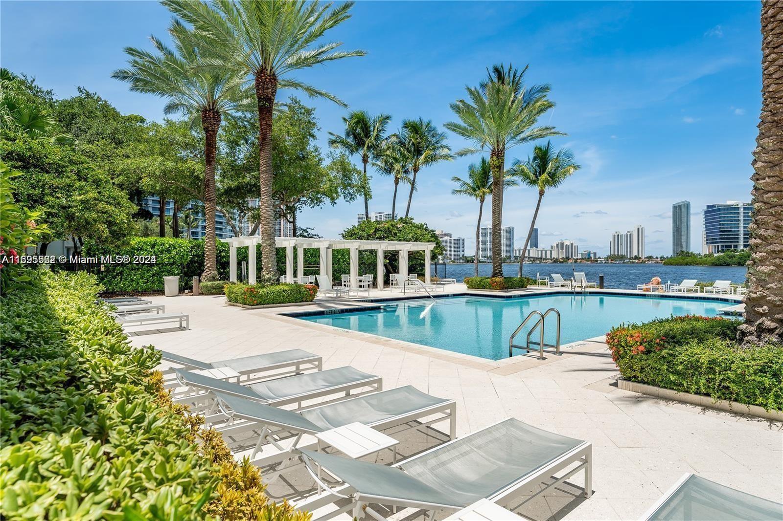 a view of a swimming pool with a patio and a yard