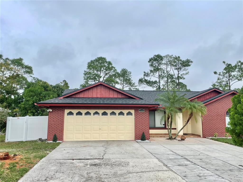 a view of a house with a yard and garage