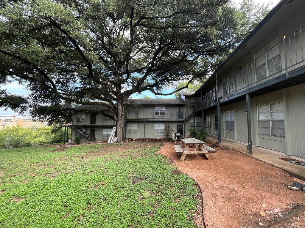 a backyard of a house with table and chairs