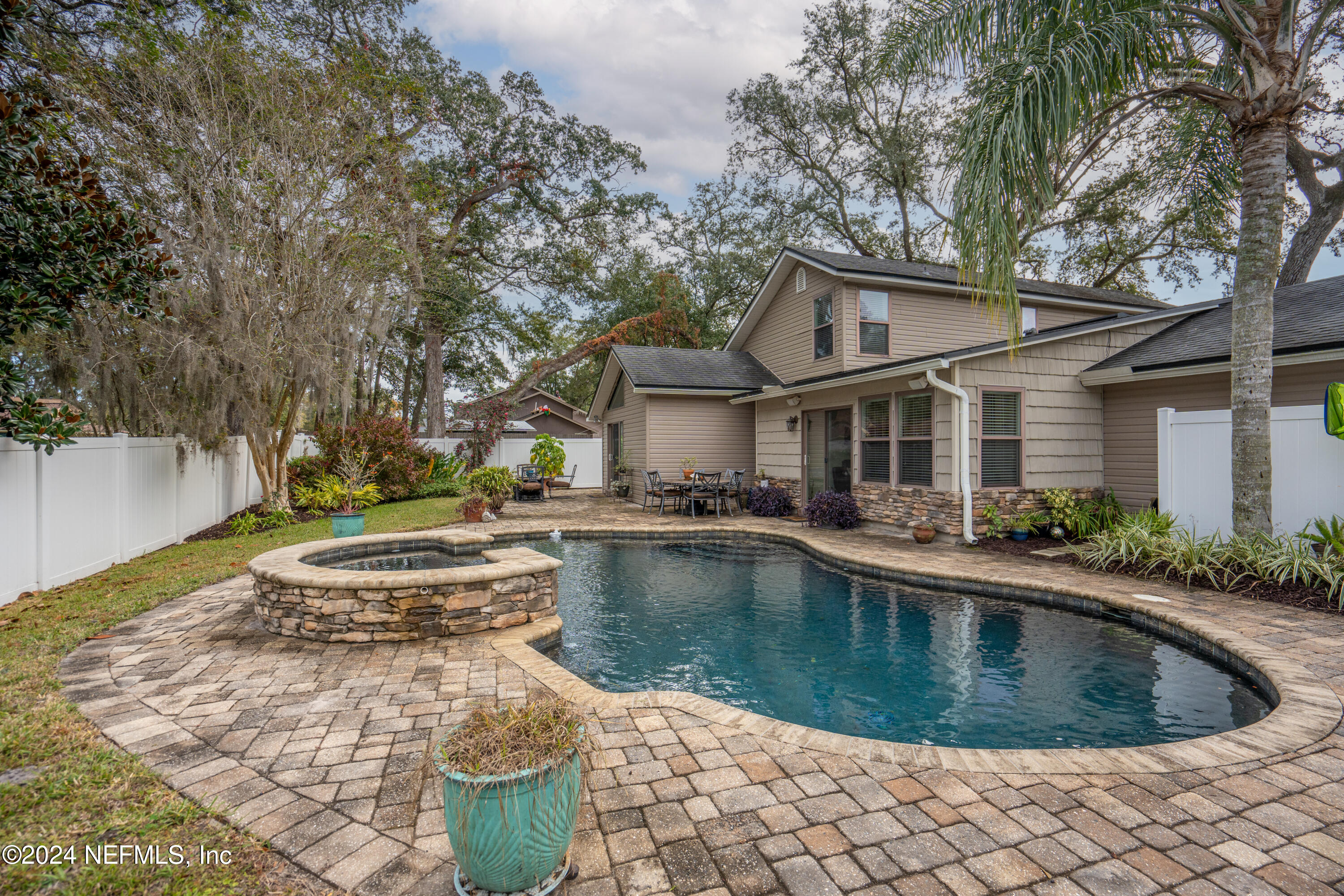 a view of a house with swimming pool and sitting area