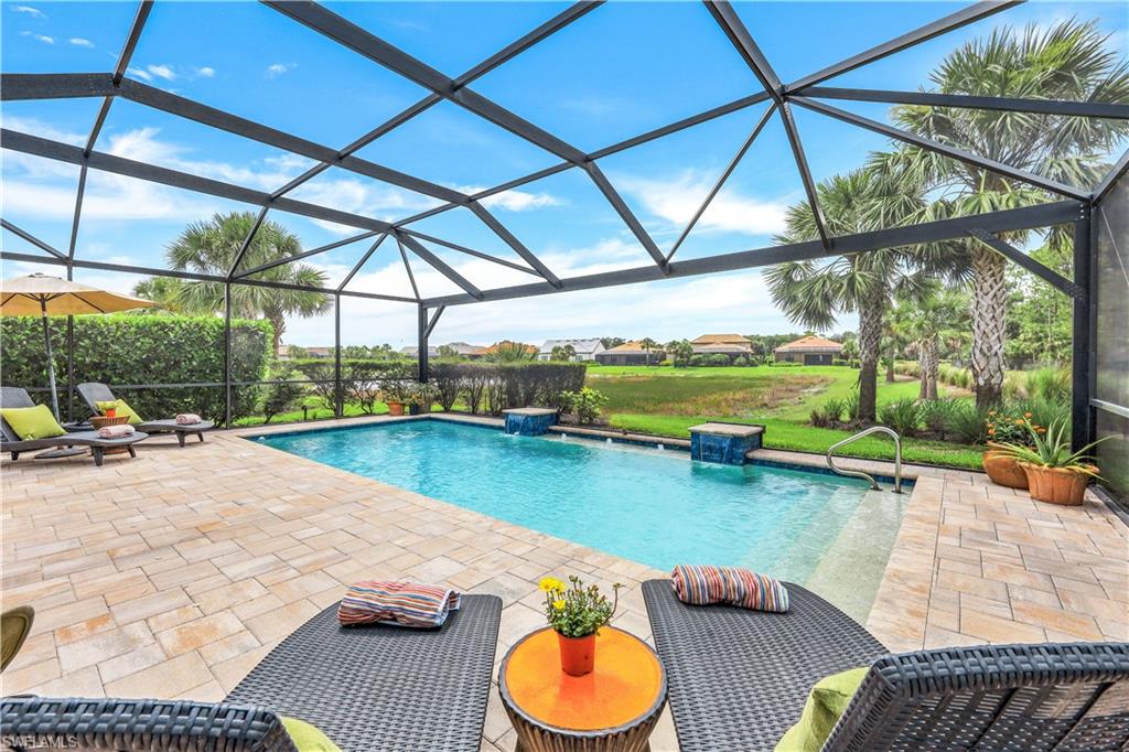 a swimming pool with lawn chairs and umbrella