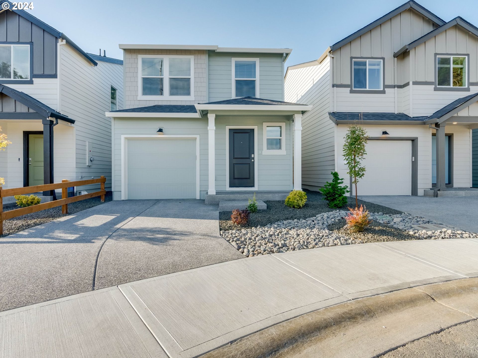 a front view of a house with lots of white garage