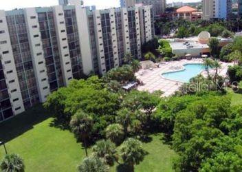 a view of a garden with tall buildings