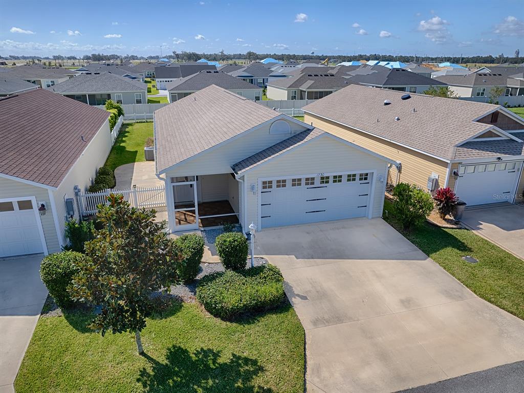 an aerial view of a house with a yard and potted plants