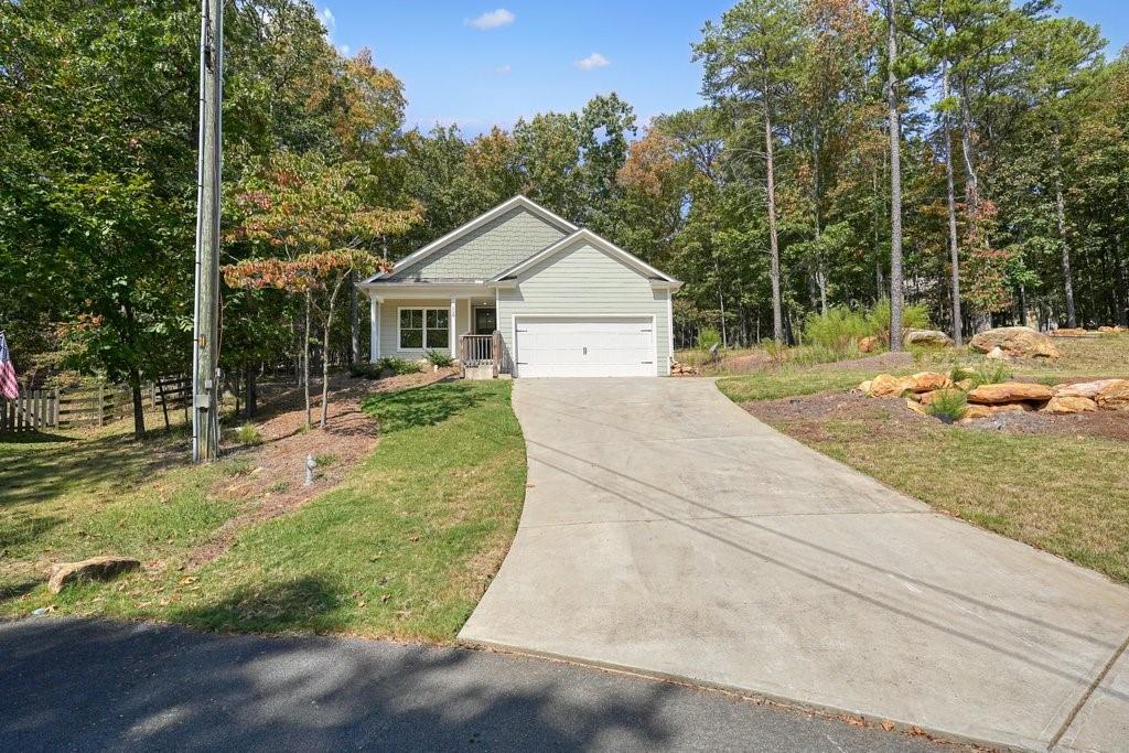 a view of a house with backyard and trees