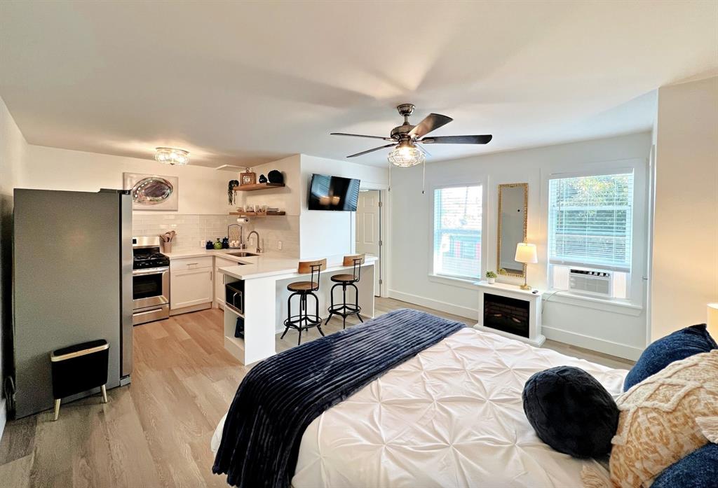 a bedroom with a bed a window and a chandelier