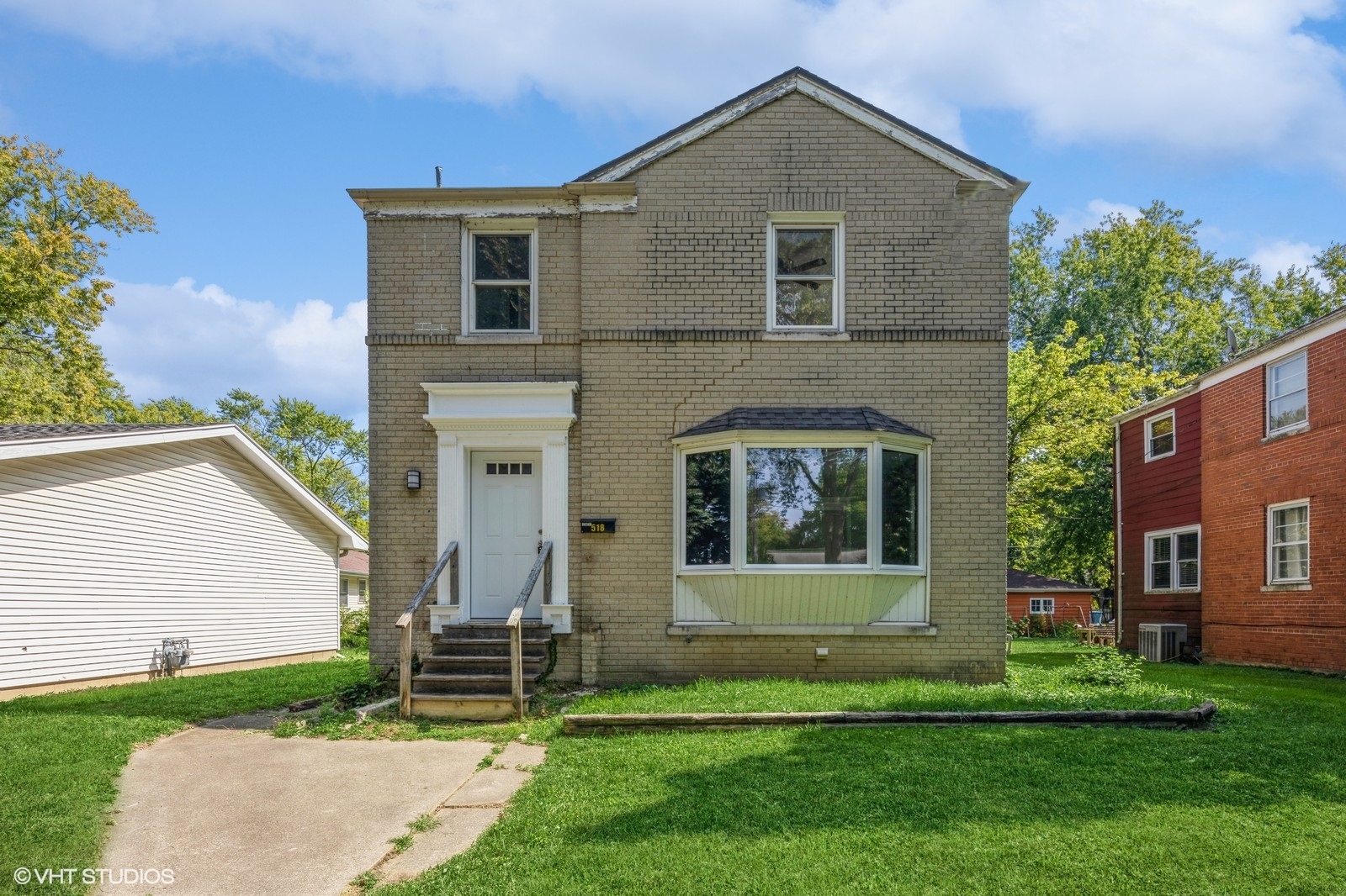 a front view of a house with a yard