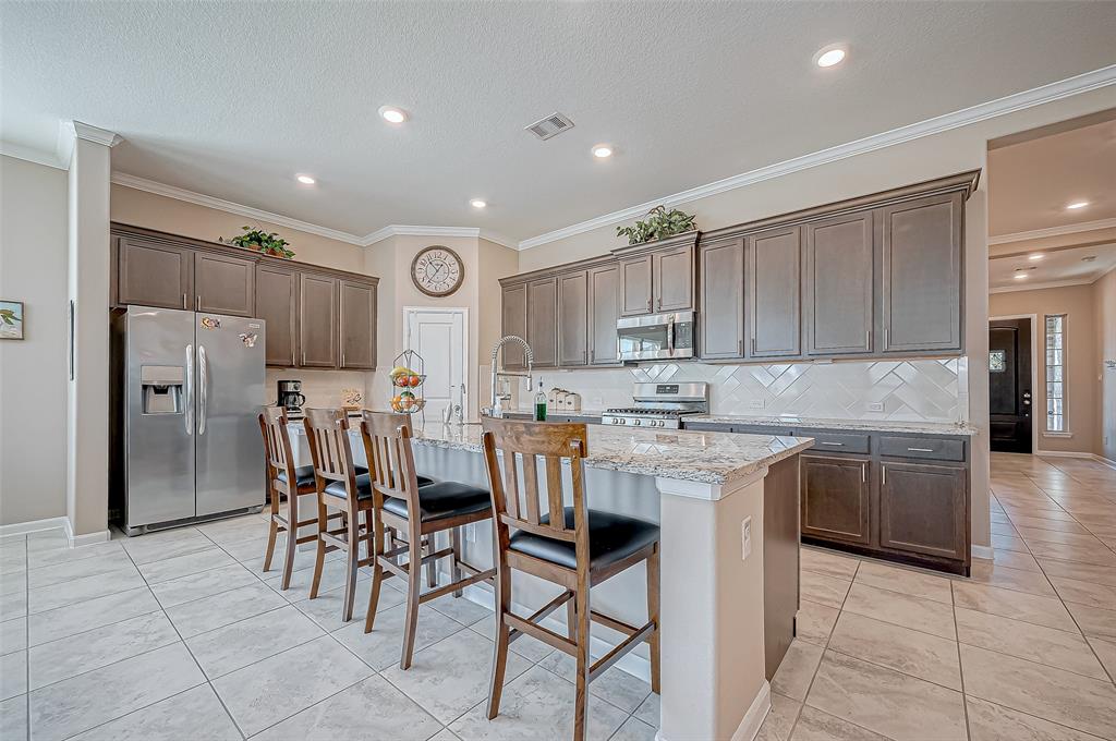 The centerpiece of this kitchen is a versatile island, perfect for casual dining or meal prep. Its open layout fosters a sense of inclusivity, whether preparing meals or entertaining guests.