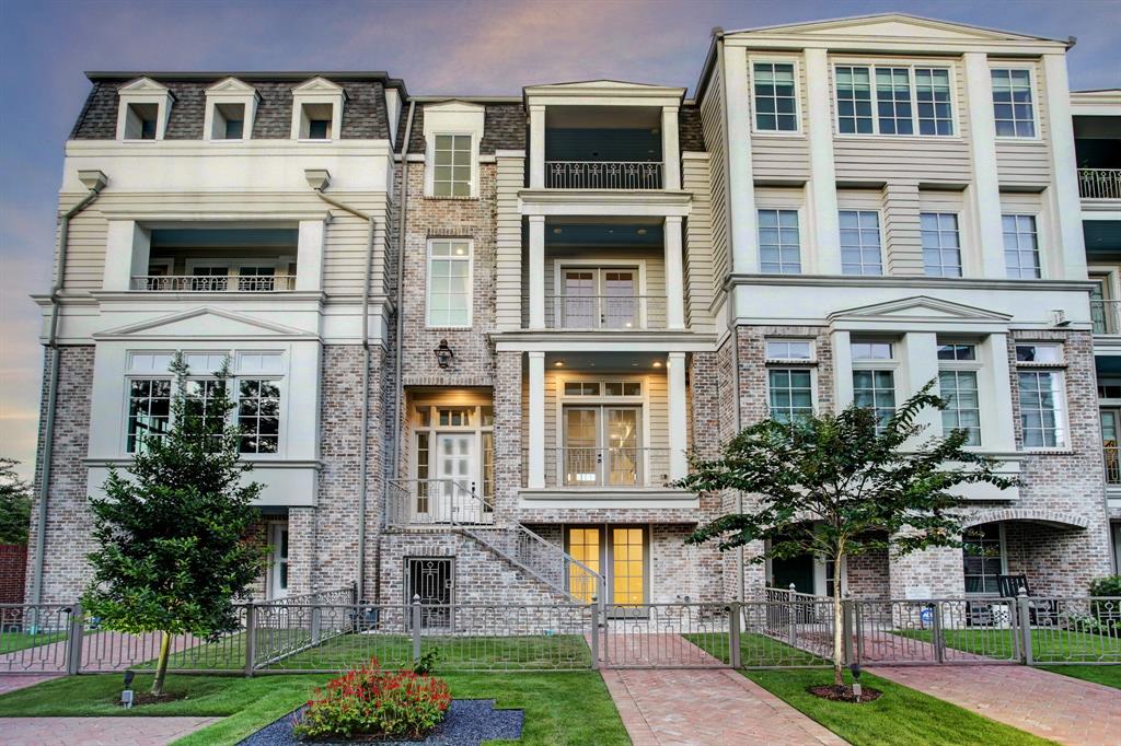 a front view of a residential apartment building with a yard