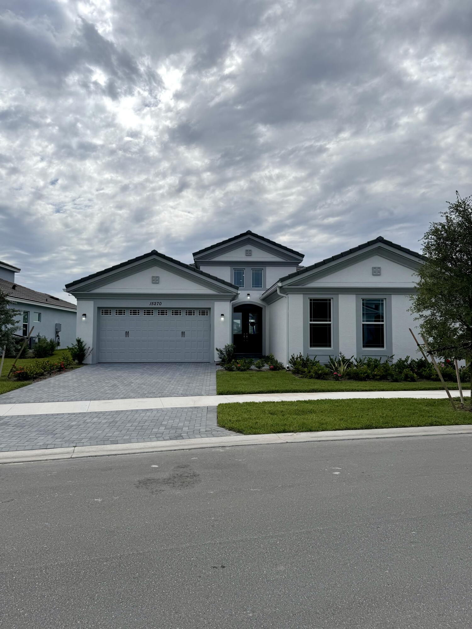 a front view of house with yard and trees