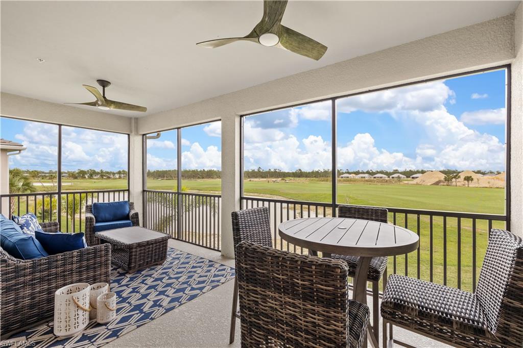 a balcony with furniture and a floor to ceiling window