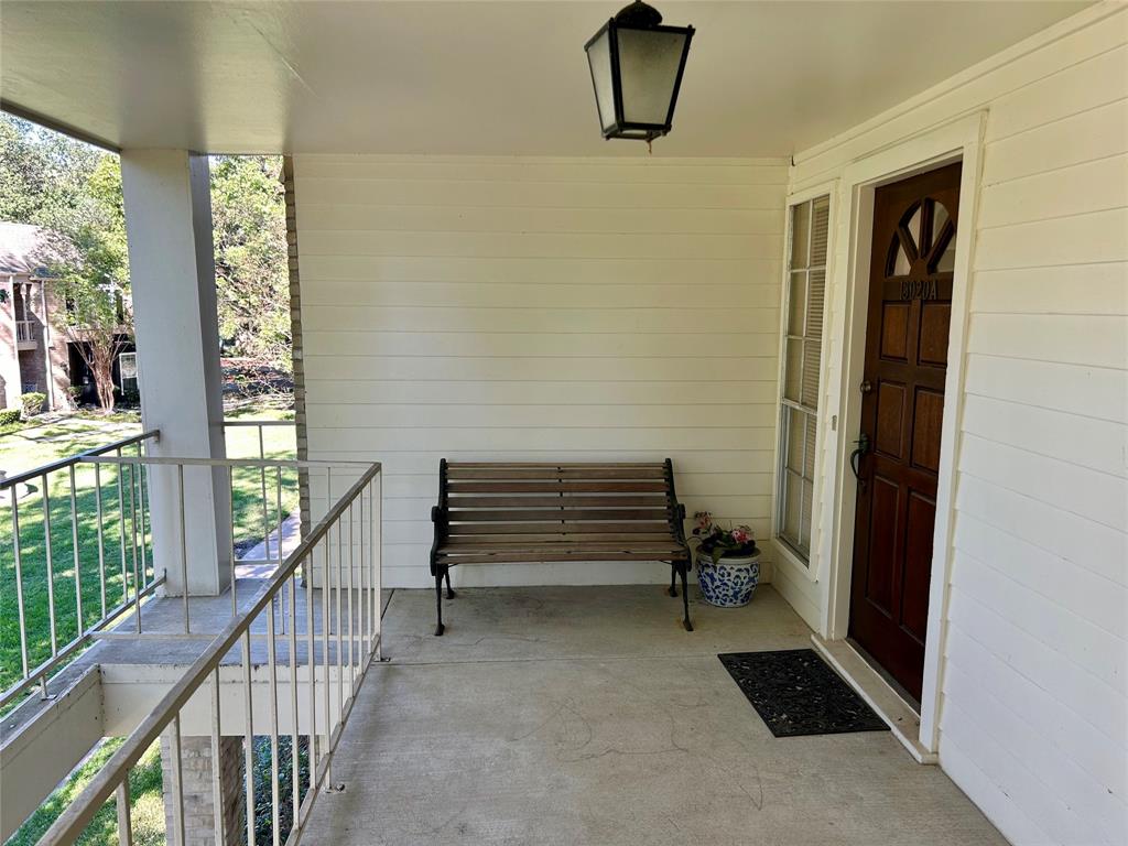 a view of staircase with a rug and a window