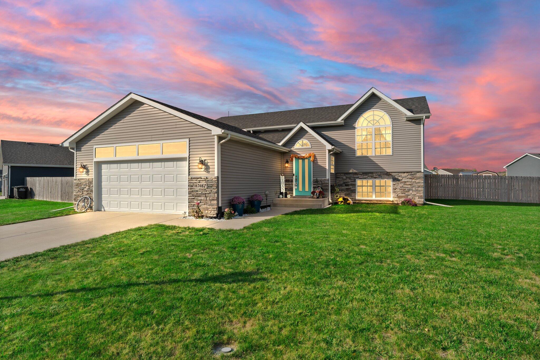 a front view of a house with a yard and garage